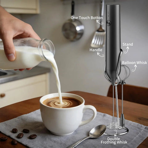 Rechargeable Handheld Milk Frother With Stand For Coffee Lattes Cappuccinos Matcha And More Quiet Fast Foam Wand In 15 To 30 Seconds USB Rechargeable Kitchen Gift Black next to cup of coffee being prepared on kitchen table.