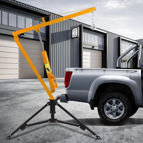 1000 Lb Hydraulic Truck Bed Crane With 360 Degree Swivel Hitch, Three Adjustable Booms, Beefy Pickup Hoist For Lifting Engines, Deer, Or Construction Gear, Yellow next to a parked truck