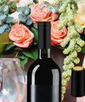 200 Piece Black Heat Shrink Wine Bottle Caps With Tear Tab 30Mm By 60Mm Pvc Shrink Sleeve Seals For Home Cellar No Hassle Application Slick Bottom Line Ready To Roll on a wine bottle with a floral background.