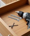 4 Sets M10x10mm Stainless Steel Hex Head Bolt Kit With Nuts, Flat And Lock Washers on a wooden drawer with a drill