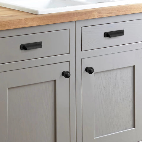 Six Pack Matte Black Cup Drawer Pulls 3 Inch Center To Center Cabinet Hardware installed on gray kitchen cabinets.