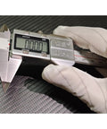 Digital Caliper With Small Point Jaw Stainless Steel Construction For Tiny Grooves And Tight Slots 0 To 6 Inch Measuring Tool With 0.0005 Inch Resolution And 0.01 Millimeter Accuracy seen on carbon fiber surface held with white gloved hand