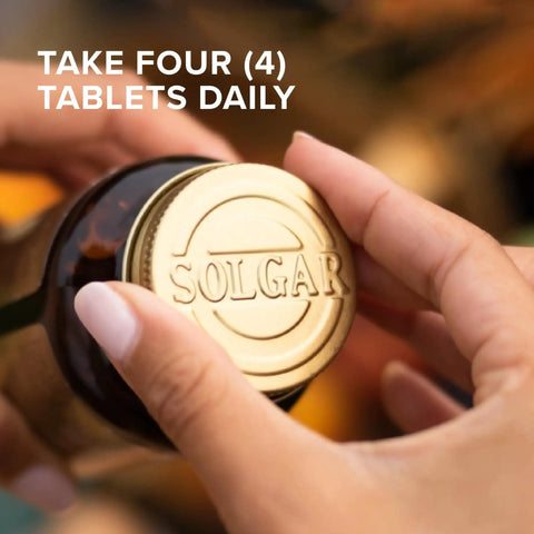 Close-up of hands opening a bottle with gold cap, labeled 'Solgar', showing a calcium complex for strong bones, 120 tablet pack.
