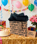 Large Kraft Birthday Gift Bag Set With Classic Black Happy Birthday Lettering Includes Greeting Card Hang Tag Kraft Envelope And Tissue Paper All In One Gift Kit For Men Boys And Kids on decorated table with balloons and cake.