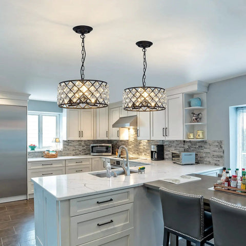 Three Light Modern Crystal Chandelier In Black Metal Farmhouse Pendant Light with adjustable chain in a modern kitchen.