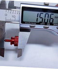 Close-up of red aluminum alloy computer case thumbscrew in caliper measurement, part of 10-pack knurled DIY replacement screws.