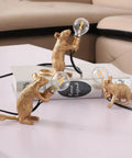 Three Style Resin Mouse Desk Lamp With LED Glow Featuring Running Sitting And Standing Cute Mouse Figures In Gold Finish For Bedroom Or Study Room Decor Plug In Table Light With Easy On Off Switch, on a book and table surface