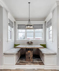 Hayden 25 Inch 4 Light Modern Farmhouse Drum Pendant Light With Cylinder Glass Shades in kitchen nook area.