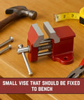 Compact One Inch Fixed Bench Vise For Jewelry Making And Crafting One And A Quarter Inch Jaw Width Tiny Yet Mighty Grip For Precision Work In Small Workspaces. Red fixed bench vise with 1.25 in jaws on a workbench