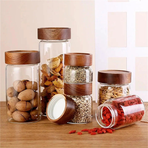 Slick High Borosilicate Glass Storage Jars With Acacia Wood Lids Gonna Keep Your Kitchen Fresh These Dope Food Canisters For Coffee Sugar Nuts Are Straight Up A Nifty Counter Top Setup with various snacks.
