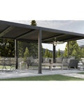 Chic Slick Farmhouse Ceiling Fan With A Tough Antique Nickel Finish And Massive Twelve Blade Windmill Design For That Fresh Modern Rustic Vibe Inside Open Living Spaces, viewed in a covered outdoor patio.
