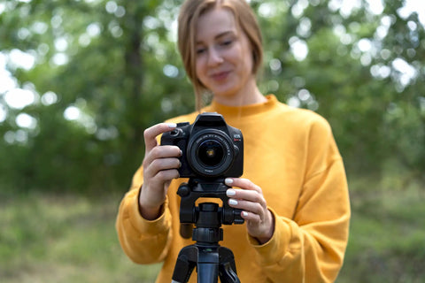Person using a camera on a tripod with 44mm Quick Release Tripod Plate Mount Adapter for Cameras and Video Gear Universal 1 3 4 Inch Square Base