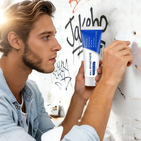Man using DIY Wall Repair Paste Kit 100g Waterproof Drywall Filler With Scraper And Sandpaper Quick Dry Putty on wall crack
