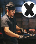 High Density Cut Resistant Arm Sleeves Two Pack Legit Tough As Nails Forearm Guards worn by chef while grilling.