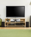 Modern living room setup with TV and speakers, showcasing Eight Outlet Pivot Plug Power Strip With Six Foot Cord And Phone Line Protection.