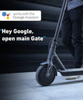 Person standing near scooter with 'Works with Google Assistant' text, showcasing Smart Gate Opener Lite With App Control And Wireless Sensor.