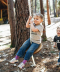 Child playing on Drifter Zip Line Seat For Kids And Adults Built To Last Heavy Duty Wooden Seat Steel Lock Carabiner Adjustable Nylon Rope