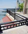 Level Up Your Outdoor Setup With These Rock Solid Railing Extenders Quick Bolt On Adds Major Height Locks In Privacy And Safety Tight Fit For Any Deck Or Patio Fence Today, view of black railing on balcony with scenic water background.
