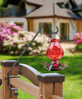 Heavy Duty 20 Inch Deck Hook With Swivel Wing Nut Design For Hummingbird Feeders holding a red feeder on a wooden railing.