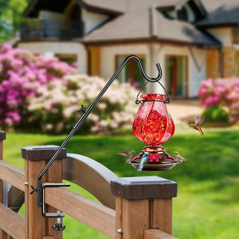 Heavy Duty 20 Inch Deck Hook With Swivel Wing Nut Design For Hummingbird Feeders holding a red feeder on a wooden railing.