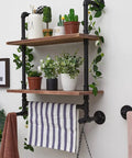 Industrial Pipe Shelves With Towel Bar For Bathroom, rustic shelves with plants and towel, black metal pipes on wall