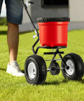 Walk Behind Broadcast Fertilizer And Seed Spreader With 90 Pound Capacity And 23 Liter Hopper, All Terrain 12.5 Inch Pneumatic Tires on lawn