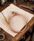 Two Pack Fire Pit Thermocouples Replacement 60x1 Cm 23.6x0.4 In Thermal Couplers shown on workbench