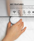 Hand placing Smart Water Leak Sensor And Alarm With 2.4 GHz Wi Fi, Flood Detection, Real Time App Notifications, No Hub Required