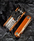 16 In 1 Bike Multi Tool Kit With Allen Wrenches And Screwdrivers For Mountain Bikes Handy On The Go Fix It Kit Chrome Vanadium Tool Set Emergency Bike Repair Gear in open position on rocky surface.