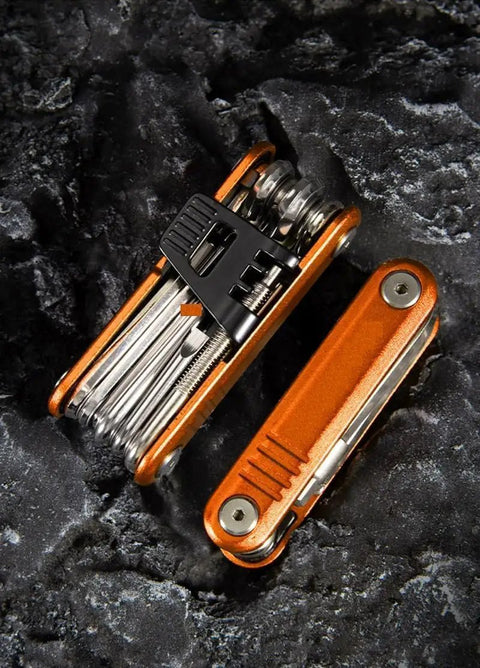 16 In 1 Bike Multi Tool Kit With Allen Wrenches And Screwdrivers For Mountain Bikes Handy On The Go Fix It Kit Chrome Vanadium Tool Set Emergency Bike Repair Gear in open position on rocky surface.