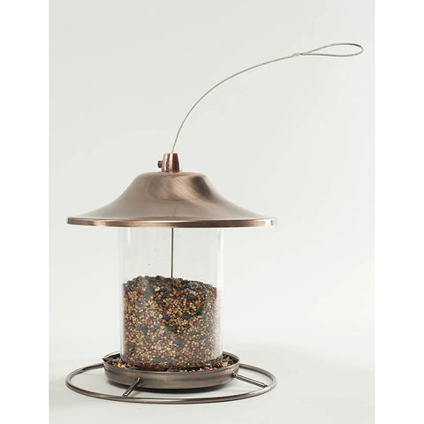 Real Deal Backyard Wild Bird Food Mix Featuring Natural Cherry Flavor And Hearty Sunflower in a glass tube feeder with copper lid.