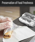 Hands wrapping sandwich in 14 By 16 Inch Aluminum Foil Sandwich Wrap Sheets 100 Pack Heat Resistant Insulation Paper For Sandwiches