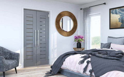 Bedroom with modern decor featuring double doors and stylish furniture.