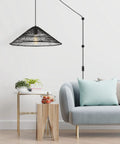 Black 1 Light Farmhouse Coastal LED Pendant With Rattan Cone Shade For Kitchen Island, Dining Room Or Bedroom, Plug In Or Hardwired Swag Lamp, 20.25 Inch Height, 180 Inch Cord, Energy Saving LED Bulb Included hanging over a modern living space.