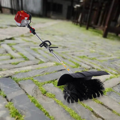 52CC Gas Walk Behind Sweeper Powered By A Muscle 2.3HP Two Stroke Engine on a cobblestone path, ready to clear debris.