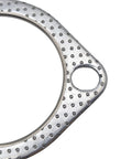 Exhaust gasket, 2.5-inch metal circular ring with a dimpled surface and central bore (close-up)