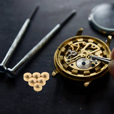 20 Piece Clock Nut Set For Repair And DIY Projects with metal movement nuts, gaskets, and watch movement parts on black surface