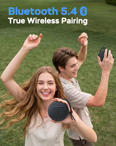 Two people enjoying music with Round One Bluetooth Speaker With IPX8 Waterproof Shower Rating And Loud HD Sound outdoors