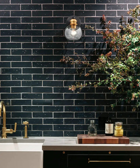 Modern Farmhouse Black And Gold Bathroom Wall Sconces Set Of Two Globe Sconce Lighting with dark tile and greenery in the bathroom