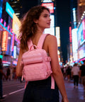 Person wearing 9L Mini Backpack For Men And Women, Lightweight Waterproof Daypack For Gym, Hiking, Travel, Sports And Running in a cityscape.