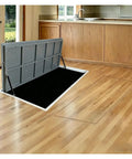 Heavy Duty Steel Hidden Floor Door With Slick Camo Look, No Fuss Install Crawl Space Hatch, Built Tough Basement Entry Panel For Homes And Garages, Flush Mount Black in a modern kitchen setting.