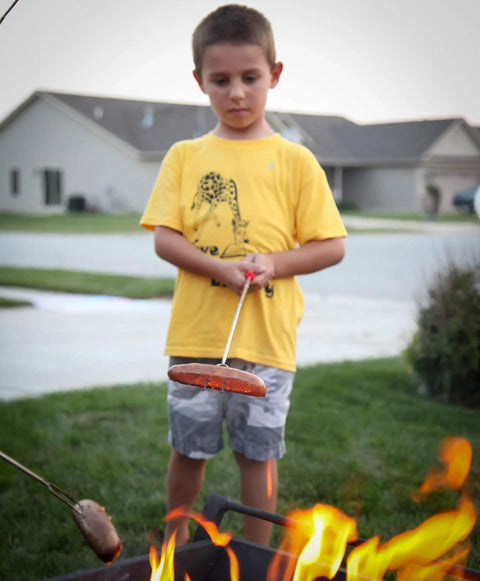 Child using Long 32 Inch Smores Sticks Kit With Stainless Steel Skewers And Smooth Wooden Handles For Marshmallow Roasting at campfire