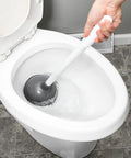 Heavy Duty Toilet Plunger With Extended Flange And Portable Caddy in action, gray rubber cup creating suction in a toilet.