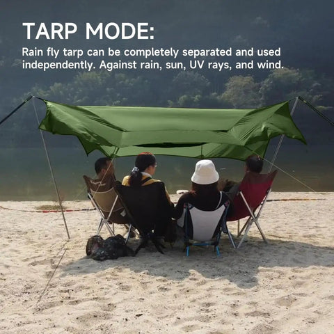 People sitting under UltraLight 11 Ft Hammock Shelter with Net and Rain Fly Tarp Four In One Camping Tent at a beach.
