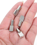 Close-up of Beefed-Up Heavy Duty Stainless Steel Shelf Pegs 5mm, 150 Pcs, Nickel Finish, held in a hand