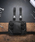 Heavy Duty Thigh Tool Pouch With Quick Release Buckles And Adjustable Waist Strap Holster For Electricians Technicians on a workbench.