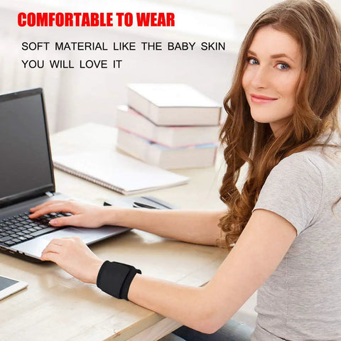 Woman wearing 2 Pack Adjustable Wrist Support Brace For Carpal Tunnel Relief while using a laptop at a desk.