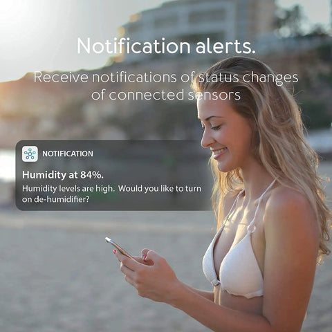 Woman receives notification on phone from All In One Smart Home Hub That Connects Z Wave Zigbee And Matter Devices Works As A SmartThings Hub And Plays Nice With Alexa And Google Assistant Keeping WiFi Strong For Fast Automations And Voice Control.