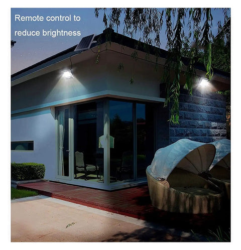 Top Shelf Solar Floodlights Featuring No Sweat Dusk To Dawn Sensor And Weatherproof Remote Control for garden lighting on a house exterior.
