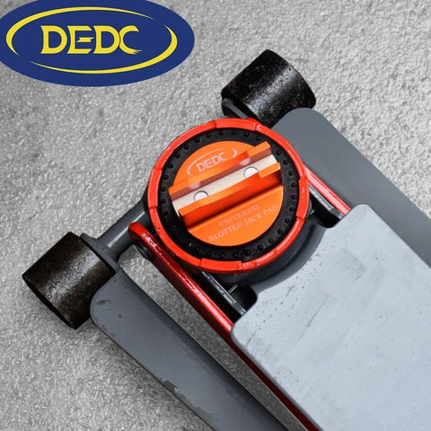 DEDC universal aluminum grooved magnetic jack pad with orange slotted insert mounted on a floor jack